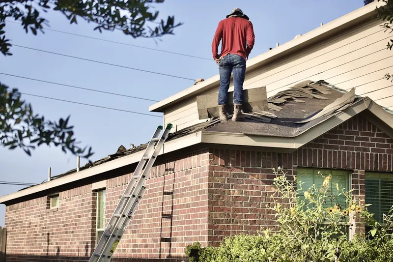 Professional roofer working on a residential roof in Berlin Center